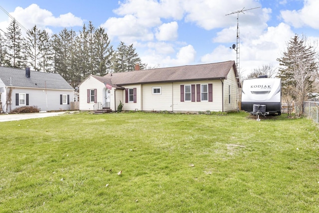 808 Longfellow Ave, Jackson, MI 49202 - view of front of property with a chimney, a front yard, and fence