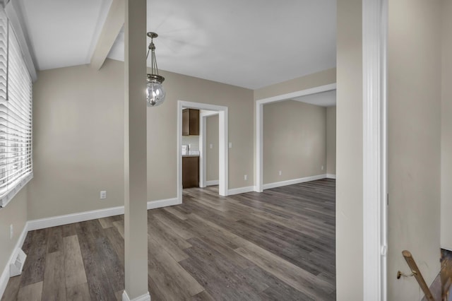 808 Longfellow Ave, Jackson, MI 49202 - interior space with baseboards, visible vents, dark wood-type flooring, and beamed ceiling