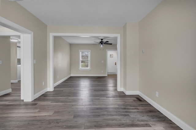 808 Longfellow Ave, Jackson, MI 49202 - spare room featuring ceiling fan, baseboards, and dark wood-style floors