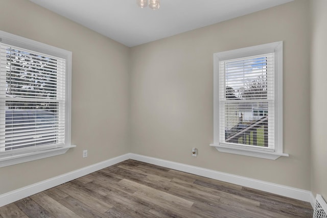 808 Longfellow Ave, Jackson, MI 49202 - spare room featuring visible vents, baseboards, and wood finished floors