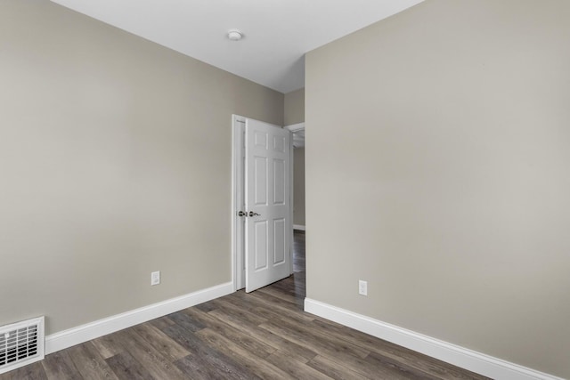 808 Longfellow Ave, Jackson, MI 49202 - empty room with baseboards, dark wood-style flooring, and visible vents