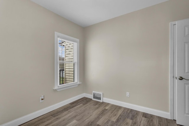 808 Longfellow Ave, Jackson, MI 49202 - spare room featuring wood finished floors, visible vents, and baseboards