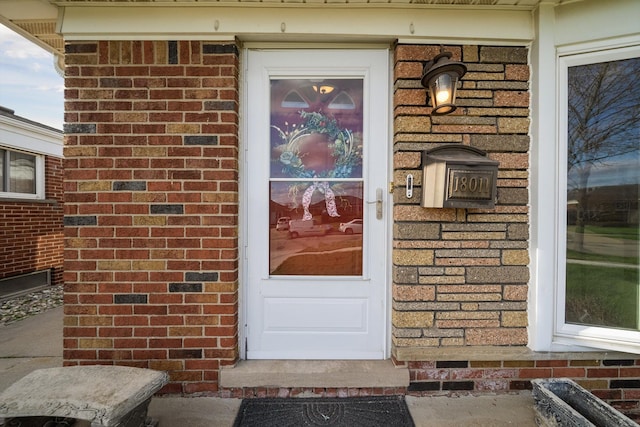 property entrance featuring brick siding