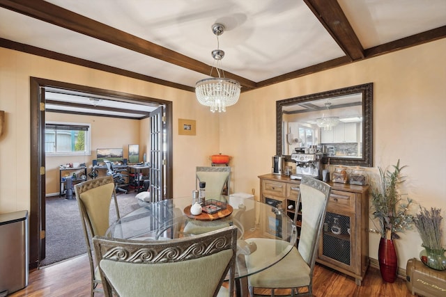 dining area with wood finished floors, beam ceiling, and a notable chandelier