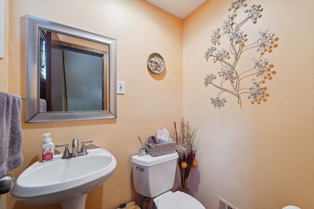 half bathroom with a sink and toilet