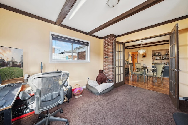 carpeted office with beamed ceiling and french doors