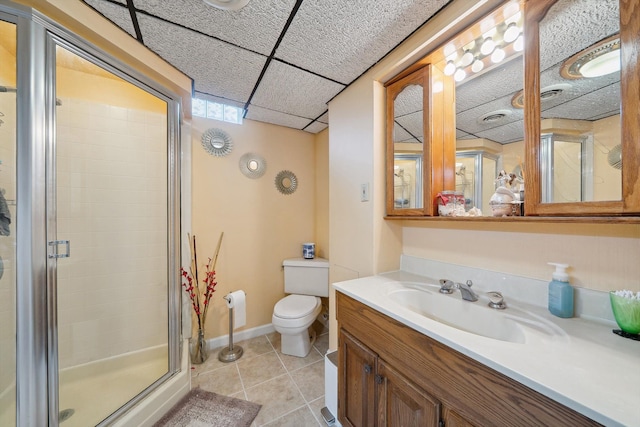 full bath featuring toilet, vanity, tile patterned flooring, and a stall shower