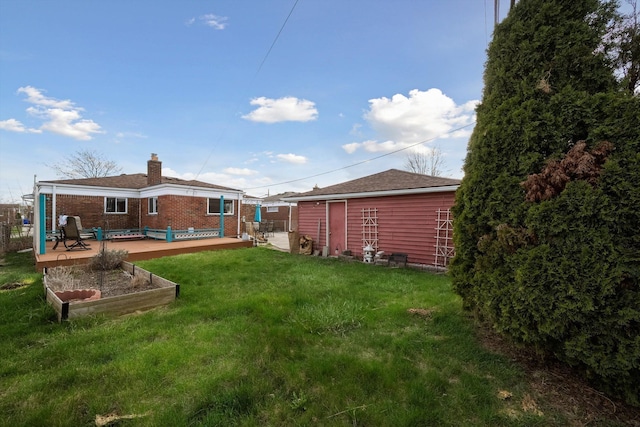 view of yard with fence and a garden