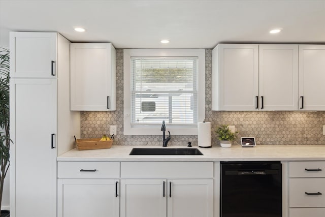 bar with decorative backsplash, a sink, recessed lighting, and black dishwasher