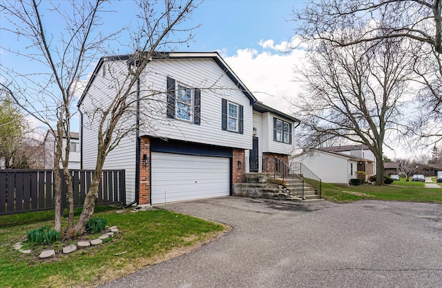 2919 Roundtree Dr, Troy, MI 48083 - split foyer home featuring brick siding, a garage, and driveway