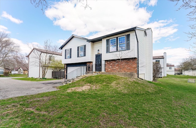 2919 Roundtree Dr, Troy, MI 48083 - raised ranch with brick siding, an attached garage, a front yard, and driveway
