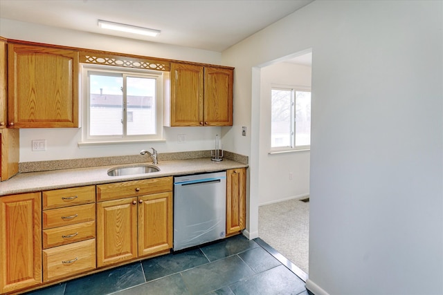 2919 Roundtree Dr, Troy, MI 48083 - kitchen with stainless steel dishwasher, a sink, light countertops, baseboards, and brown cabinets