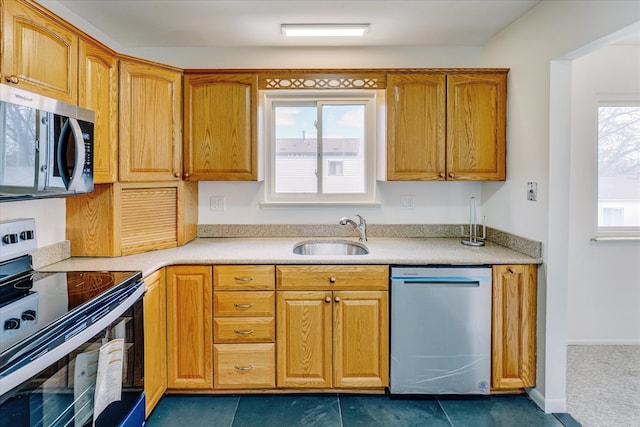 2919 Roundtree Dr, Troy, MI 48083 - kitchen with appliances with stainless steel finishes, a sink, light countertops, and brown cabinetry