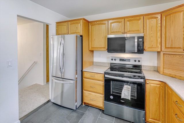 2919 Roundtree Dr, Troy, MI 48083 - kitchen featuring appliances with stainless steel finishes, light countertops, and dark tile patterned floors