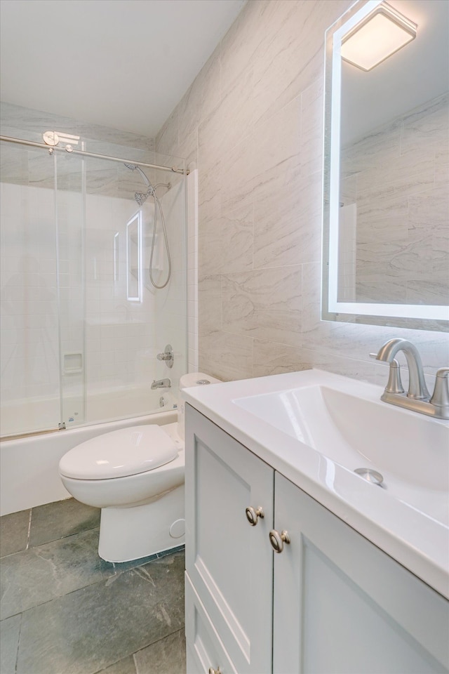 2919 Roundtree Dr, Troy, MI 48083 - full bathroom with tile walls, toilet, vanity, and shower / bath combination with glass door
