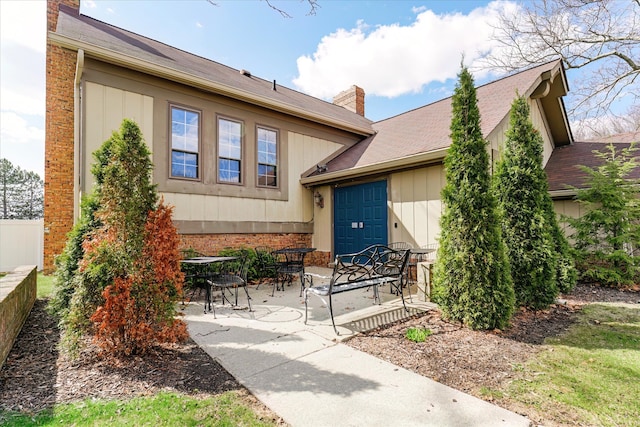 2919 Roundtree Dr, Troy, MI 48083 - doorway to property featuring a chimney and a patio