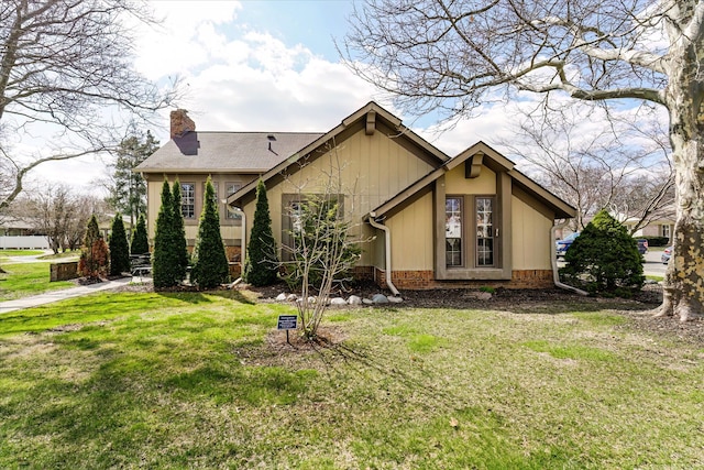 2919 Roundtree Dr, Troy, MI 48083 - back of house featuring a chimney and a yard