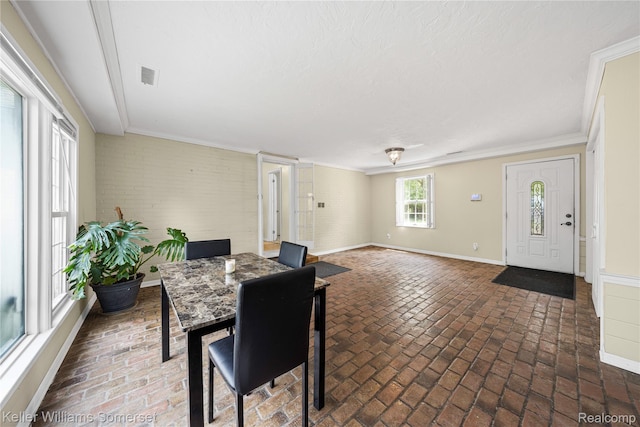 21700 W 13 Mile Rd, Beverly Hills, MI 48025 - dining area featuring brick flooring, baseboards, ornamental molding, and brick wall