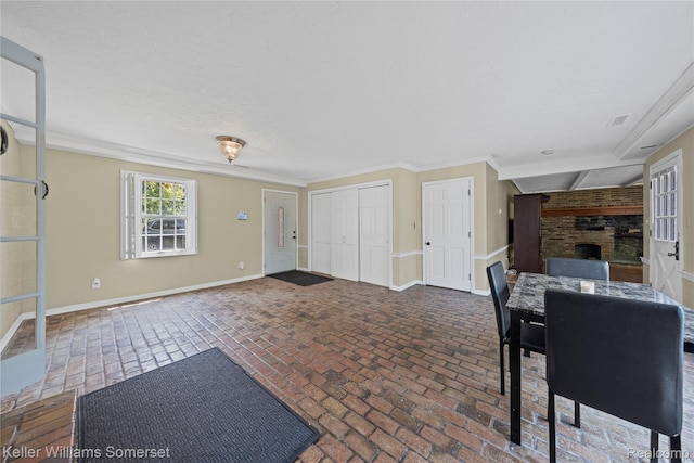 21700 W 13 Mile Rd, Beverly Hills, MI 48025 - unfurnished dining area with a large fireplace, brick flooring, baseboards, and crown molding