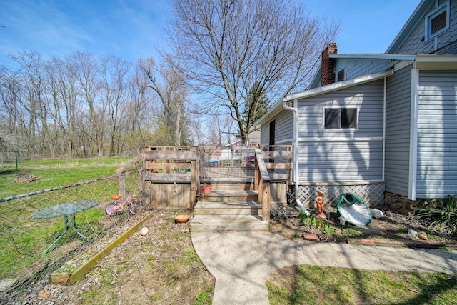 124 Broad St, Brooklyn, MI 49230 - view of side of home featuring a chimney, fence, and a deck