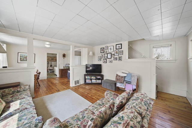 124 Broad St, Brooklyn, MI 49230 - living room with baseboards, visible vents, and hardwood / wood-style flooring