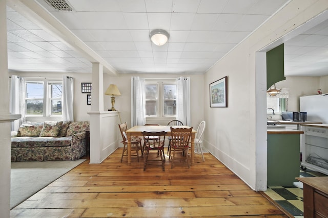 124 Broad St, Brooklyn, MI 49230 - dining area featuring baseboards, visible vents, and light wood-style floors