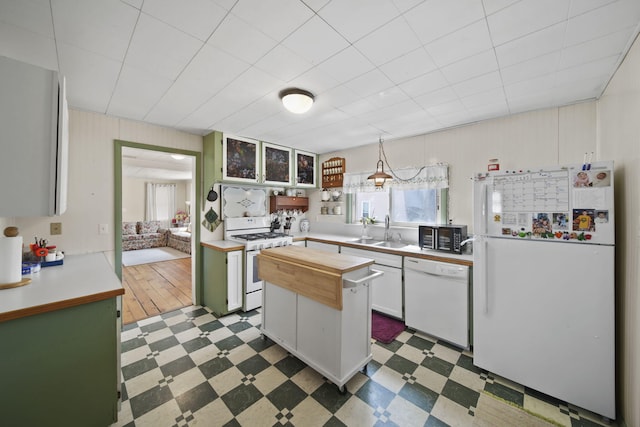 124 Broad St, Brooklyn, MI 49230 - kitchen with tile patterned floors, a sink, white appliances, wood counters, and glass insert cabinets