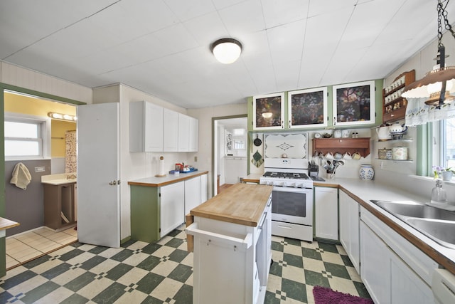 124 Broad St, Brooklyn, MI 49230 - kitchen featuring white cabinets, a sink, white appliances, light floors, and wood counters