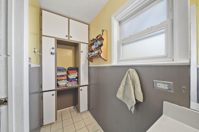 124 Broad St, Brooklyn, MI 49230 - bathroom with tile patterned floors and a wainscoted wall