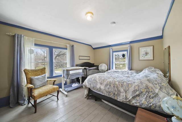 124 Broad St, Brooklyn, MI 49230 - bedroom with ornamental molding and hardwood / wood-style floors