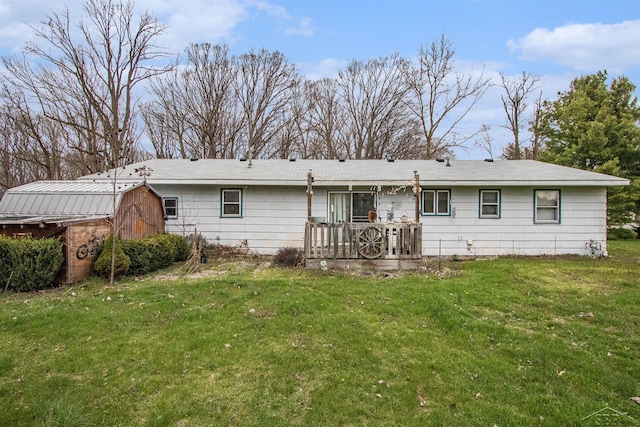 back of house with an outdoor structure and a yard