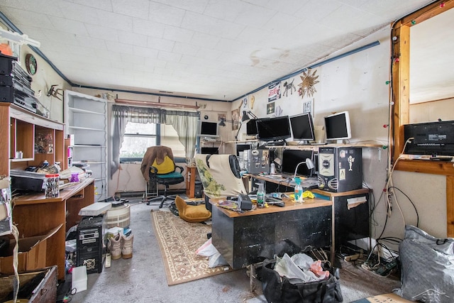 office area featuring unfinished concrete flooring