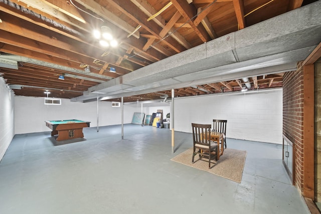 finished below grade area featuring concrete block wall and pool table