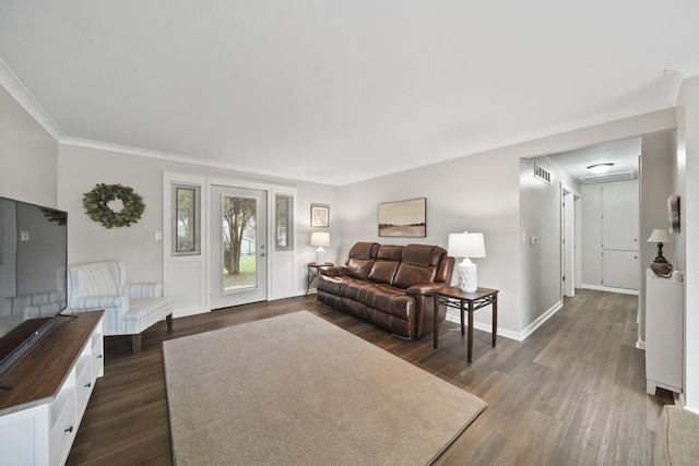 living area featuring baseboards, dark wood-style flooring, crown molding, and visible vents