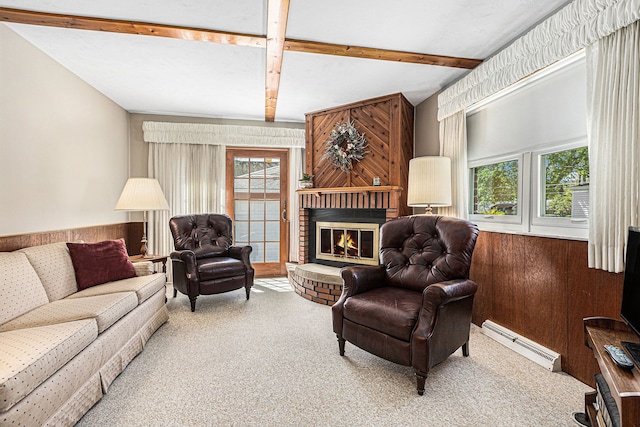 carpeted living area with a baseboard radiator, beam ceiling, a healthy amount of sunlight, and a fireplace