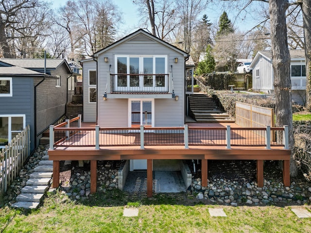 rear view of house featuring a wooden deck and stairs
