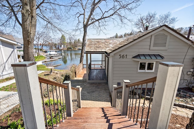 exterior space featuring stairway and a water view