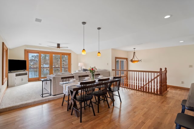dining area with ceiling fan, lofted ceiling, visible vents, and light wood-style flooring
