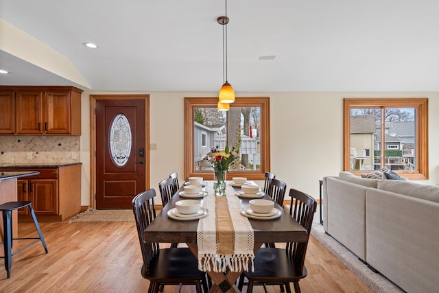 dining room featuring recessed lighting, plenty of natural light, visible vents, and light wood finished floors