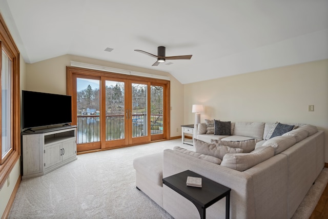 living area featuring ceiling fan, lofted ceiling, carpet floors, and visible vents