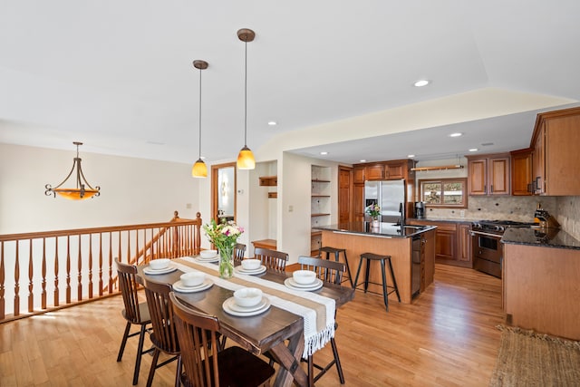 dining space with light wood-style flooring and recessed lighting
