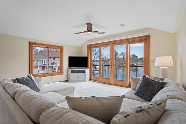 carpeted living room featuring vaulted ceiling, french doors, ceiling fan, and plenty of natural light