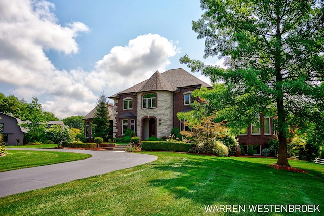 3550 64th Ave, Zeeland, MI 49464 - french country style house with a front yard and stone siding