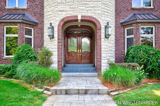 3550 64th Ave, Zeeland, MI 49464 - property entrance featuring french doors, a standing seam roof, brick siding, and a metal roof