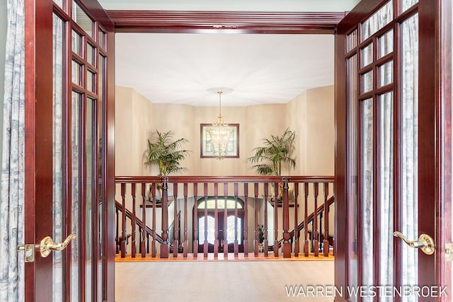 3550 64th Ave, Zeeland, MI 49464 - hallway featuring a chandelier, an upstairs landing, and carpet
