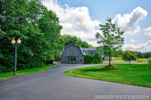 3550 64th Ave, Zeeland, MI 49464 - dutch colonial featuring a gambrel roof, a front lawn, curved driveway, and a barn