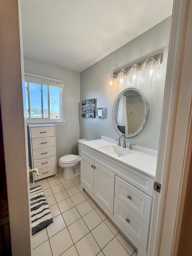 bathroom with vanity, toilet, and tile patterned floors