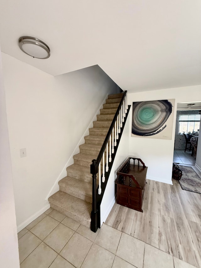 stairs with baseboards and wood finished floors