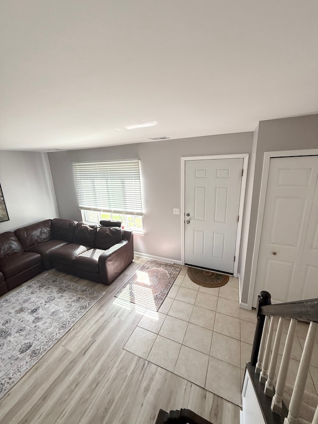living area with baseboards and light wood-style flooring