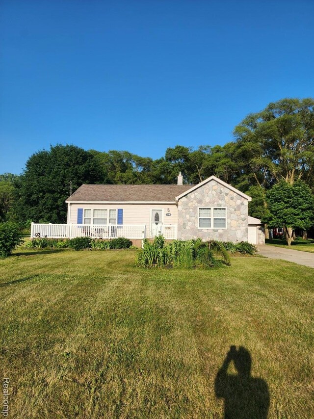 5140 Eastview Rd, Clarkston, MI 48346 - view of front facade with a front lawn, a chimney, and stone siding